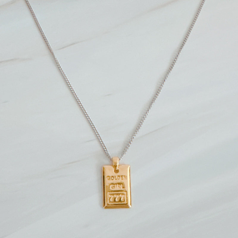 Elegant two-tone necklace featuring a sleek rectangular gold bar pendant on a silver-metal chain, blending modern edge with classic shine