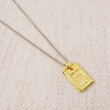 Elegant two-tone necklace featuring a sleek rectangular gold bar pendant on a silver-metal chain, blending modern edge with classic shine