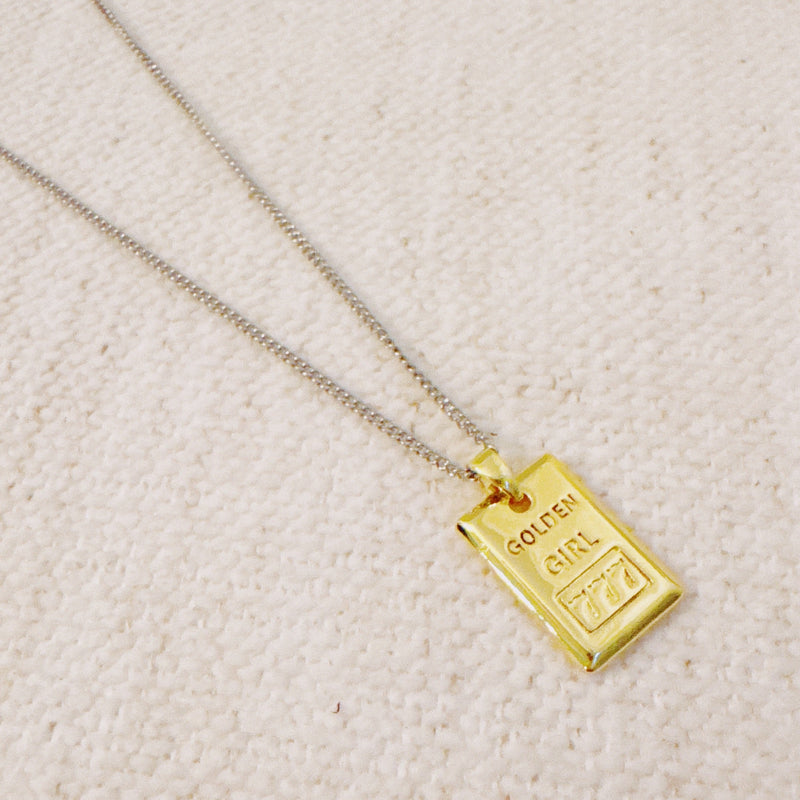 Elegant two-tone necklace featuring a sleek rectangular gold bar pendant on a silver-metal chain, blending modern edge with classic shine