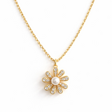 Gold-tone necklace featuring a daisy-inspired pendant with a luminous pearl center surrounded by sparkling crystal-studded petals. The design blends classic elegance with a fresh, feminine touch, perfect for layering or wearing solo.