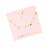 Gold chain necklace featuring spaced letter charms that spell “NANA” in a polished gold finish, designed as a meaningful everyday or giftable piece.