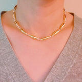 Gold-toned necklace featuring sleek tube beads – minimalist and modern layered style