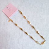 Gold-toned necklace featuring sleek tube beads – minimalist and modern layered style
