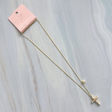 An elegant gold-tone necklace featuring a cross pendant made of luminous pearls with a sparkling crystal at the center. The pendant hangs from a 24-inch chain with a 2-inch extender, creating a timeless and graceful look perfect for layering or wearing solo.