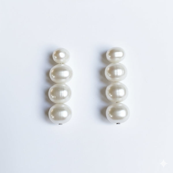 Elegant dangle earrings featuring a graduated design of genuine freshwater pearls in descending sizes. These classic and sophisticated earrings bring a timeless touch to any outfit, perfect for both everyday wear and special occasions.