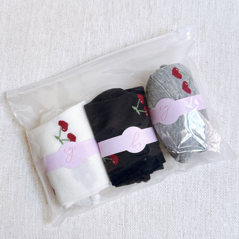 Playful set of three socks featuring cherry and heart motifs in fun, perfect for adding a cute and fruity flair to your everyday style.