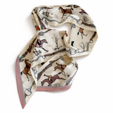 Scarf with horse and equestrian pattern on a white background. Silky narrow twilly scarf featuring an equestrian-inspired print with galloping horses, bridle straps, and classic riding motifs, designed for styling around the neck, wrist, or handbag.
