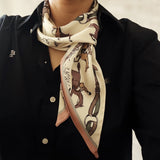 Person wearing a black coat with a patterned scarf
