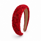 A red textured fabric headband with sequins and glitter, shown on a clean white background.
