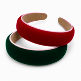 Two velvet headbands stacked on a white background, one in deep red and one in dark green, both with light pink inner trim.