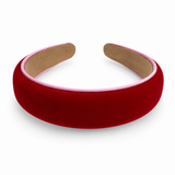 A wide, padded velvet headband in deep red with a light pink inner lining and tan padding, shown on a clean white background.