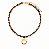 Brown beaded necklace with a gold clasp on a white background