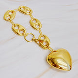 A gold-plated brass horse bit design dangle bag charm with a heart-shaped end.