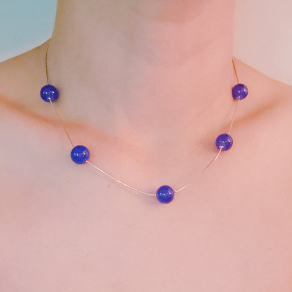  Elegant necklace featuring flowing indigo-toned beads—designed to capture graceful movement and add a touch of sophistication to any look.
