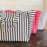 Oversized beach bag made from plush terry cloth material, designed with sturdy handles and a spacious interior—perfect for carrying towels, swimwear, and summer essentials in cozy, absorbent style.