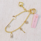 Gold bag charm with key, lock, and ring details – elegant purse accessory