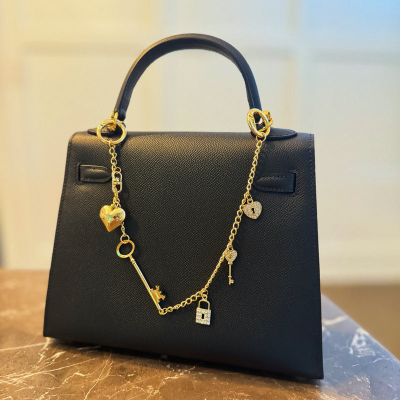 Gold bag charm with key, lock, and ring details – elegant purse accessory