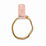 pink card holding thinner and wider Herringbone chains layered together as an anklet in yellow gold tone on the white background