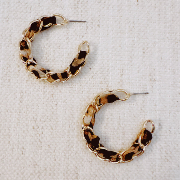 Gold chain hoop earrings wrapped with a leopard print scarf for a bold, fashion-forward statement look.
