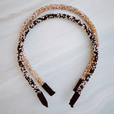 Set of two festive sparkle headbands in black and brown tones, each adorned with glittery “Let’s Celebrate” text and colorful accents, perfect for parties or special occasions.