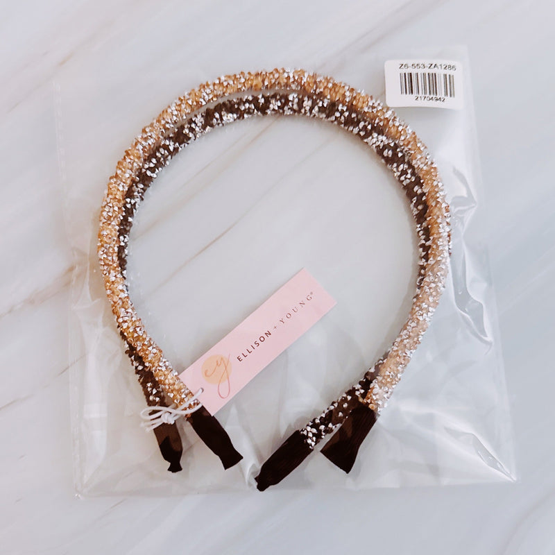 Set of two festive sparkle headbands in black and brown tones, each adorned with glittery “Let’s Celebrate” text and colorful accents, perfect for parties or special occasions.
