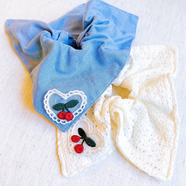 Set of two square hair scrunchies featuring cherry print and love-themed designs.