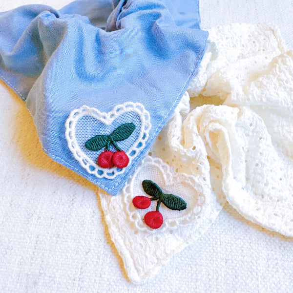 Set of two square hair scrunchies featuring cherry print and love-themed designs.