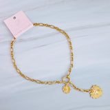 Gold-toned statement necklace featuring a bold chain and a cascading duo of engraved heart-shaped medallion pendants.