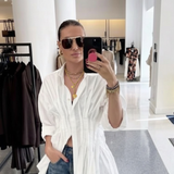 Gold-toned statement necklace featuring a bold chain and a cascading duo of engraved heart-shaped medallion pendants.