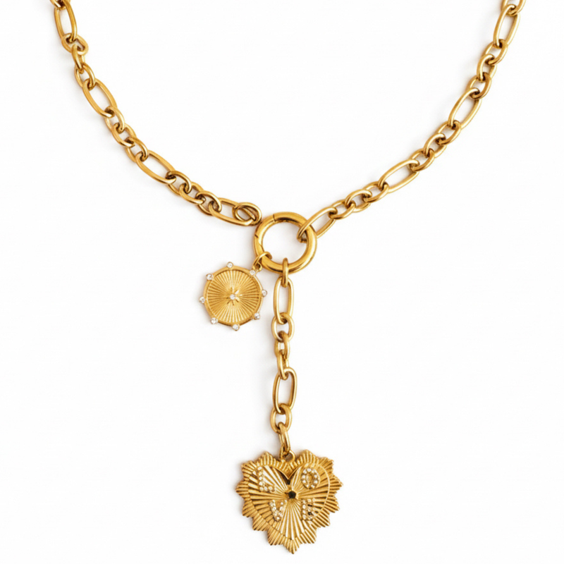 Gold-toned statement necklace featuring a bold chain and a cascading duo of engraved heart-shaped medallion pendants.