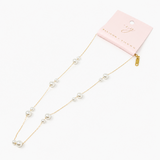 Pearl necklace with gold chain on a white background, featuring a pink card with 'Jewelry' branding.
