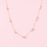 Pearl necklace on a pink background