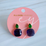 A pair of drop earrings featuring a uniquely sculpted irregular oval piece with a sparkle finish, topped by a small, contrasting accent element for added texture and elegance.