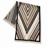 A rectangular woven throw blanket with a geometric pattern of beige, black, and white stripes, featuring fringe on two short ends, displayed on a clean white background.