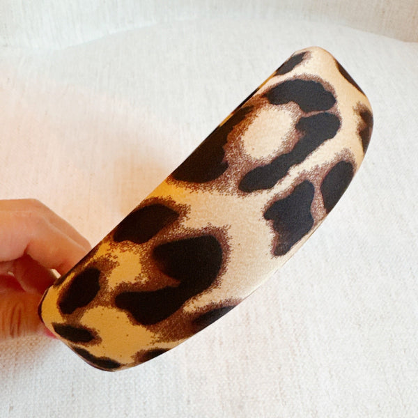 Chic and bold headband crafted from smooth satin fabric with a stylish leopard print—perfect for adding a touch of luxe and wild flair to any outfit.