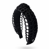 Black woven headband on a white background