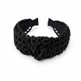 Black woven headband on a white background