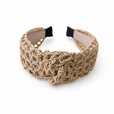 Beige woven headband on a white background