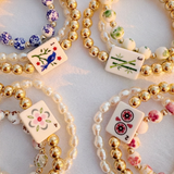 Bracelets with decorative tiles on a light background