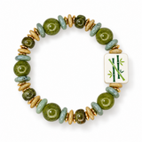 A beaded stretch bracelet featuring olive green stone beads, light blue-green disc beads, gold-toned spacer rings, and a white rectangular tile with a green bamboo design, shown on a white background.