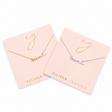 Two necklaces on pink cards with 'ELLISON + YOUNG' branding.
