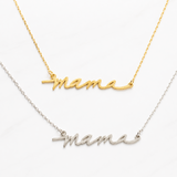Gold and silver 'mama' necklaces on a white background