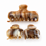 Set of three tortoiseshell patterned hair clips on a white background