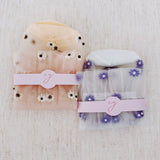 Set of two delicate sheer socks adorned with charming mini daisy patterns, offering a light and feminine touch to your everyday look.