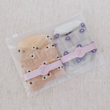 Set of two delicate sheer socks adorned with charming mini daisy patterns, offering a light and feminine touch to your everyday look.