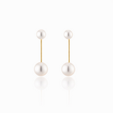 A pair of modern pearl earrings featuring a sleek gold-tone bar connecting two lustrous pearls—one smaller and one larger—for a minimalist yet elegant look. These dual pearl drop earrings combine classic sophistication with a modern silhouette.