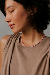 Single strand necklace featuring natural stone beads in warm, earthy tones with subtle color variations and organic shapes, offering a bohemian and grounded look perfect for everyday wear or layering.