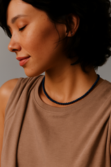 Single strand necklace featuring natural stone beads in warm, earthy tones with subtle color variations and organic shapes, offering a bohemian and grounded look perfect for everyday wear or layering.