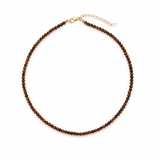 Single strand necklace featuring natural stone beads in warm, earthy tones with subtle color variations and organic shapes, offering a bohemian and grounded look perfect for everyday wear or layering.