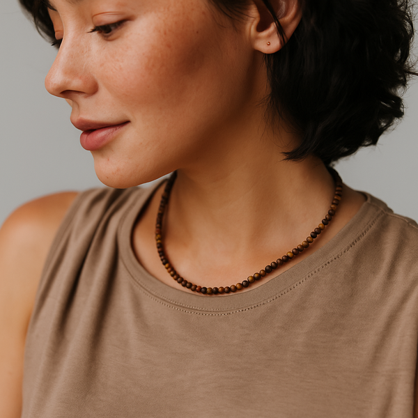 Single strand necklace featuring natural stone beads in warm, earthy tones with subtle color variations and organic shapes, offering a bohemian and grounded look perfect for everyday wear or layering.